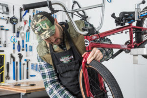 bike shop technician working on red bike